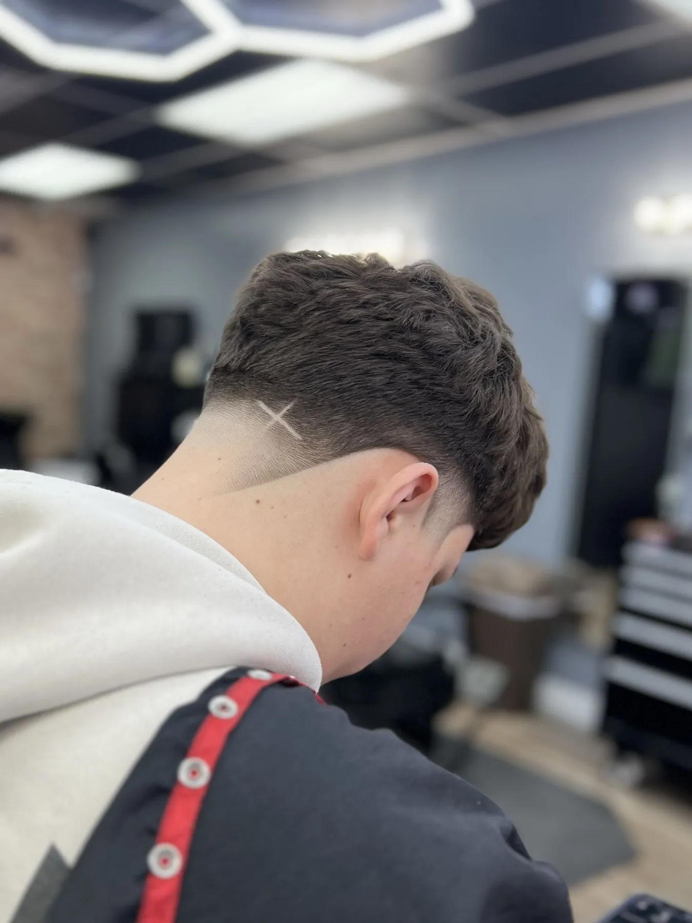 Drop fade with a shaved part line